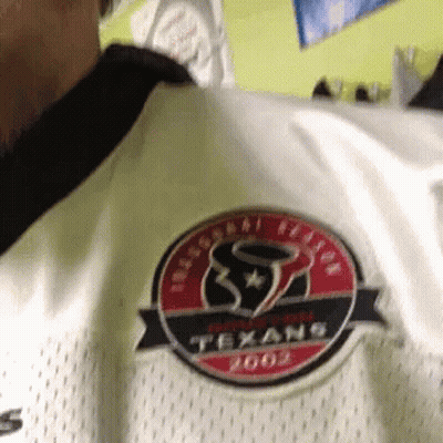 A Person Wearing A White Texans Jersey With A Red And Black Logo GIF