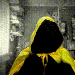 A Person Wearing A Yellow Cape With A Hood GIF