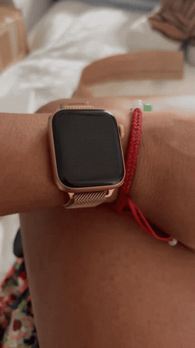 A Person Wearing An Apple Watch With A Red Bracelet On Their Wrist GIF
