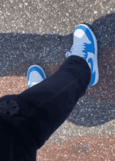A Person Wearing Blue And White Nike Shoes GIF