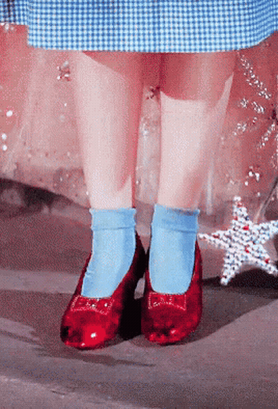 A Person Wearing Blue Socks And Red Shoes With A Bow GIF