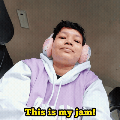 A Person Wearing Ear Muffs And A Purple Hoodie Says " This Is My Jam " GIF