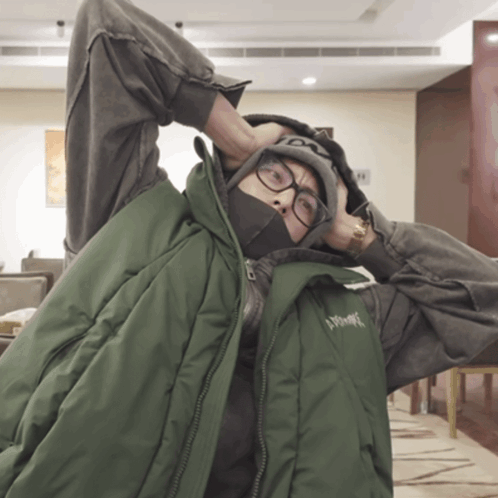 A Person Wearing Glasses And A Green Vest That Says ' Xtreme ' On It GIF