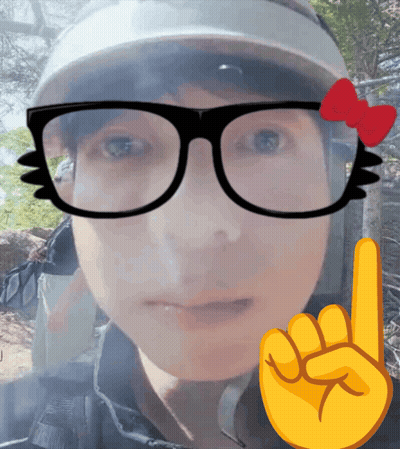 A Person Wearing Glasses And A Hat With A Red Bow On Them GIF