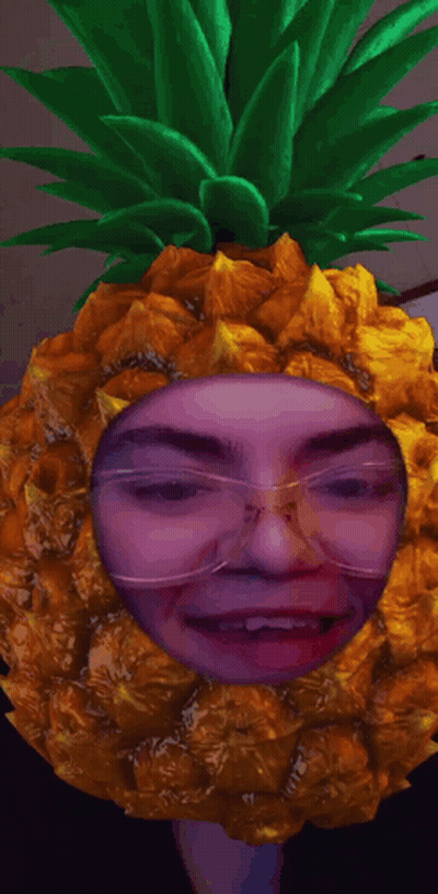 A Person Wearing Glasses And A Pineapple Headpiece GIF