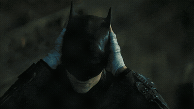 A Person Wearing Gloves Covering Their Face With Their Hands GIF