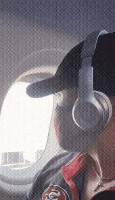 A Person Wearing Headphones And A 49Ers Jacket GIF