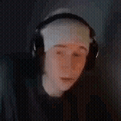 A Person Wearing Headphones And A Bandage On Their Head Is Looking At A Computer Screen . GIF