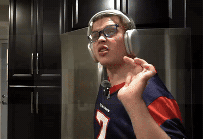 A Person Wearing Headphones And A Texans Jersey GIF