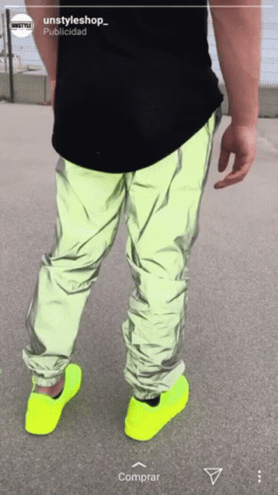 A Person Wearing Neon Yellow Shoes And A Black Shirt With The Words Unstyleshop On The Bottom GIF