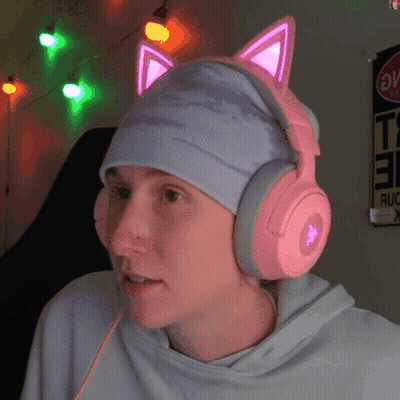 A Person Wearing Pink Headphones And A Hat With Cat Ears On It GIF