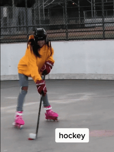 A Person Wearing Roller Skates And Hockey Gloves GIF