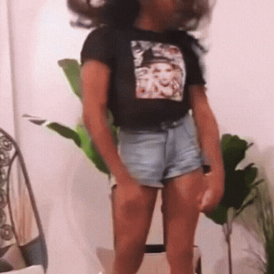 A Person Wearing Shorts And A T-Shirt With A Picture Of A Woman On It GIF