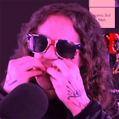 A Person Wearing Sunglasses Has A Tattoo On Their Arm That Says Iconic But Meh GIF