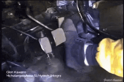 A Person Wearing Yellow Gloves Is Working On A Vehicle GIF
