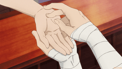 A Person With A Bandage On Their Wrist Is Holding Another Person 'S Hand GIF