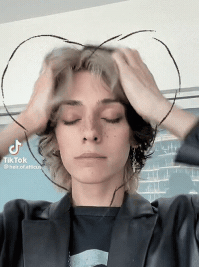 A Person With A Heart Drawn On Their Head Has Tiktok Written On The Bottom Right GIF