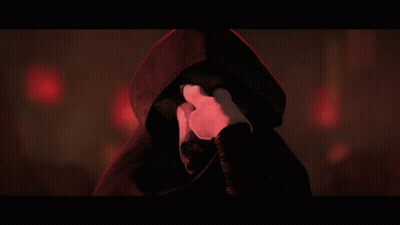 A Person With A Hood On Covering Their Face With Their Hands GIF