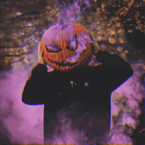 A Person With A Pumpkin On Their Head With Smoke Coming Out Of It 'S Eyes GIF