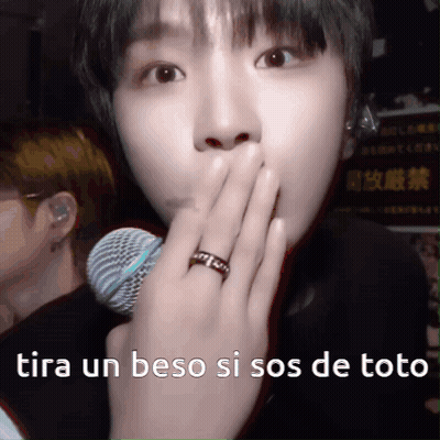 A Person With A Ring On Their Finger Is Covering Their Mouth With Their Hand GIF