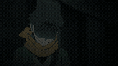 A Person With A Scarf Around Their Neck Stands In The Dark GIF