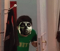 A Person With A Skeleton Mask On Their Face Is Wearing A Green Shirt That Says Hpt GIF
