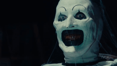 A Person With A White Mask On Their Face Screaming GIF