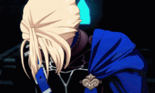 A Person With Blonde Hair And A Blue Cape GIF