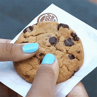 A Person With Blue Nail Polish Is Holding A Burger King Chocolate Chip Cookie GIF