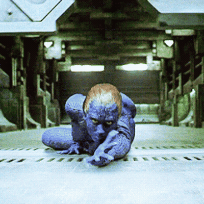 A Person With Blue Paint On Their Body Is Crawling On The Ground GIF
