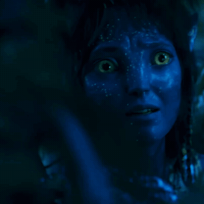 A Person With Blue Paint On Their Face Is Covering Their Mouth With Their Hand GIF