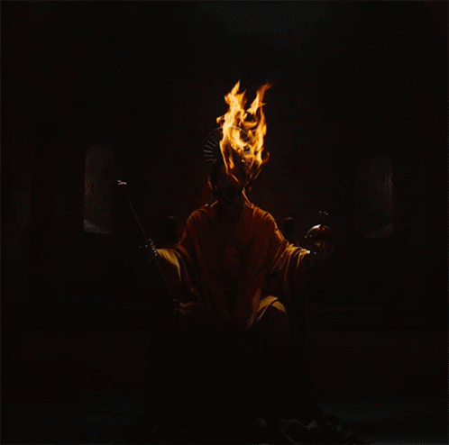 A Person With Flames Coming Out Of Their Head And A Crown On Their Head GIF
