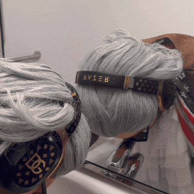 A Person With Gray Hair Wearing Headphones With Bvser Written On Them GIF