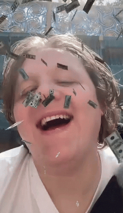 A Person With Money Falling On Their Face And One Dollar Bills On Their Face GIF