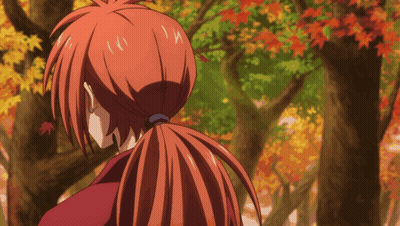 A Person With Red Hair In A Ponytail Looking At Trees GIF