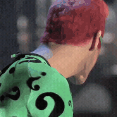 A Person With Red Hair Is Wearing A Green Shirt With A Black Question Mark GIF