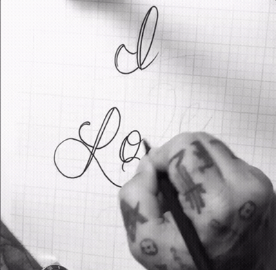 A Person With Tattoos On Their Fingers Is Writing The Word Love GIF
