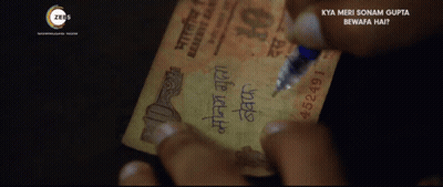 A Person Writing On A 10 Rupee Note GIF