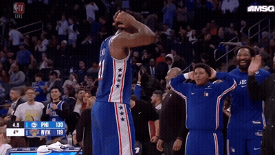 A Philadelphia 76Ers Basketball Player Stands On The Court With His Hands On His Head GIF