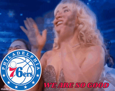 A Philadelphia 76Ers Logo Is Behind A Woman In A Dress GIF