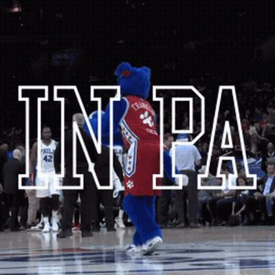 A Philadelphia 76Ers Mascot Dancing On A Basketball Court GIF