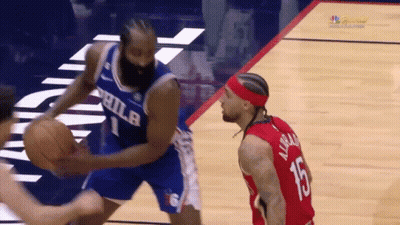A Philadelphia Basketball Player Dribbles The Ball While Another Player Watches GIF