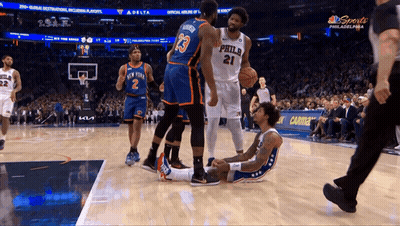 A Philadelphia Basketball Player Lays On The Floor During A Game GIF