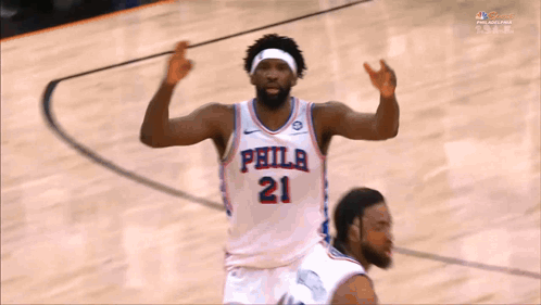A Philadelphia Basketball Player Wearing Number 21 Is Celebrating On The Court GIF