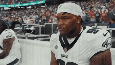 A Philadelphia Eagles Player Sits On The Sidelines During A Game GIF