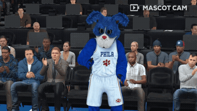 A Philadelphia Mascot Is Standing In Front Of A Crowd Of People GIF