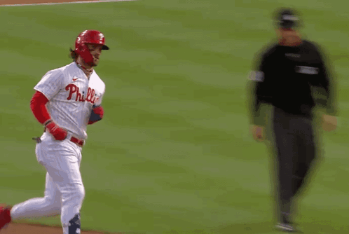 A Philadelphia Phillies Baseball Player Is Running Towards A Referee GIF