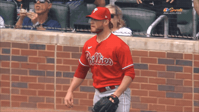A Philadelphia Phillies Baseball Player Is Standing On The Field GIF