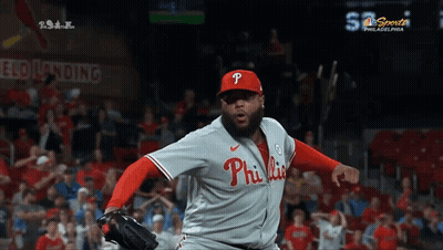 A Philadelphia Phillies Pitcher Throws A Ball In Front Of A Crowd GIF