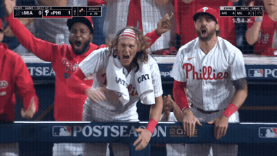 A Philadelphia Phillies Player Stands In The Dugout With His Teammates GIF